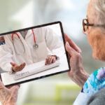 Older woman using telehealth on her tablet