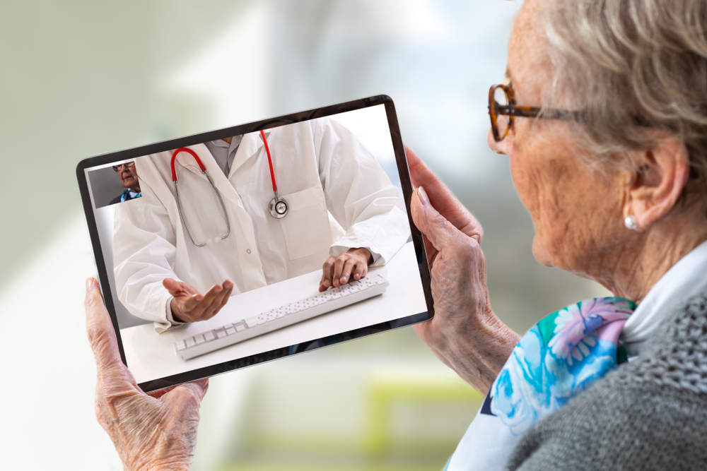 Older woman using telehealth on her tablet